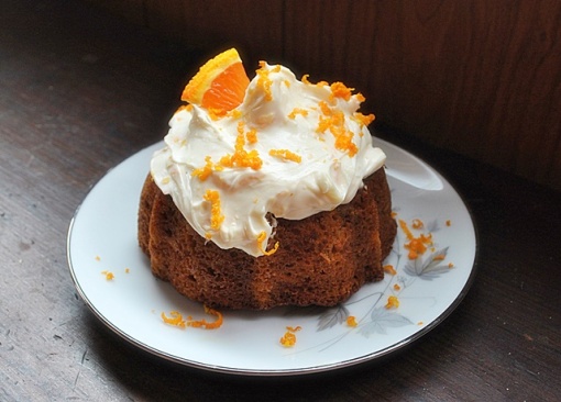Carrot apple ginger cake topped with creame cheese frosting and orange zest 